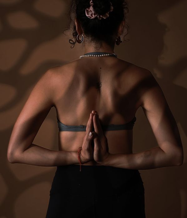 Woman in a calm yoga pose, embodying harmony and balance.